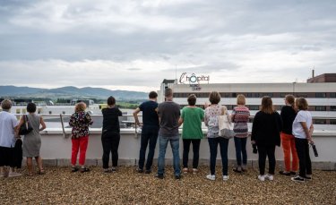 sur un toit un groupe de personnes regardent l'hôpital de Villefranche